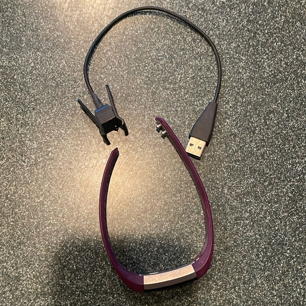 Purple Fitbit with charger